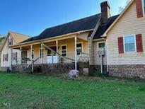 Ranch-style home with covered porch and large yard at 340 Cedar Grove Dr, Henderson, NC 27537