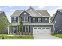 Two-story home with gray siding, white trim, and a two-car garage at 516 Lemon Daisy Ln, Knightdale, NC 27545