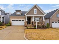 Craftsman style home with two-car garage, stone accents and a welcoming front porch at 1211 Ballerina Ln, Durham, NC 27703