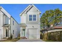 Newly constructed home with gray and white exterior, one-car garage, and a well-manicured lawn at 406 Cherry St, Fuquay Varina, NC 27526