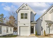 White two-story house with a garage and modern design at 408 Cherry St, Fuquay Varina, NC 27526