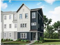 Three-story home with modern farmhouse style and two-toned siding at 1212 Holding Village Way, Wake Forest, NC 27587