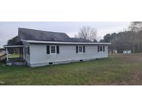 Side view of a single-story home with white siding and black shutters at 332 Bass Lake Road Rd, Holly Springs, NC 27540