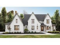Modern white brick home with dark gray roof, wood accents, and black-framed windows at 1724 Legacy Ridge Ln, Wake Forest, NC 27587