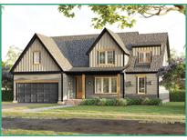 Two-story craftsman style home with gray siding, a dark gray shingle roof, and a two-car garage at 212 Rawhide Dr, Louisburg, NC 27549