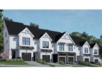 Modern three-story townhouses with attached garages and landscaped yards at 4041 Elk Creek Ln # 16, Raleigh, NC 27612