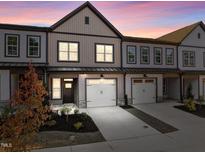 Modern townhome with two-car garage and landscaped front yard at 509 Excelsior Ct, Rolesville, NC 27587