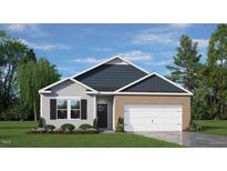 Brick and shingle two-story home with a two-car garage and landscaped lawn at 60 Fair Child Rd, Spring Lake, NC 28390