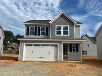Two-story home with gray siding, white garage door, and black windows at 96 Brooklynn Trl, Angier, NC 27501