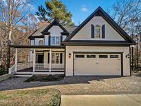 Two-story house with white siding, black accents, and a paved driveway at 4700 Linaria Ln, Fuquay Varina, NC 27526