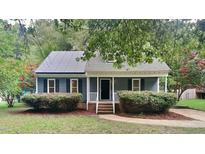 Charming blue house with solar panels and landscaped yard at 111 Whithorne Dr, Garner, NC 27529