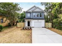 Charming two-story home with a fenced yard and driveway at 807 E Harnett St, Dunn, NC 28334