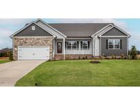 Newly constructed home with stone accents and a two-car garage at 11300 International Dr, Middlesex, NC 27557