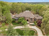 Luxury home nestled in wooded lot with circular driveway at 32520 Archdale Dr, Chapel Hill, NC 27517