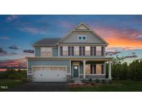 Two-story home with gray siding, white trim, and a welcoming front porch at 604 Mohinda Way, Willow Springs, NC 27592