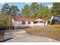 Ranch style home with red metal roof, deck and paved driveway at 292 Valley Forge S Way, Cameron, NC 28326