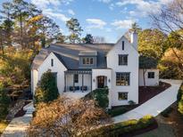 Stunning white brick home with gray roof and landscaped yard at 3319 Milton Rd, Raleigh, NC 27609
