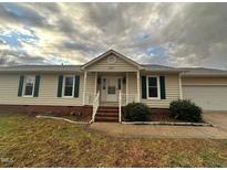 Ranch home features a classic design, brick accents, and a spacious yard at 427 Overman Drive Dr, Burlington, NC 27215