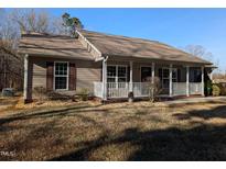 House exterior featuring a front porch and landscaped yard at 8067 Nc Hwy 96, Oxford, NC 27565