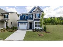 Charming two-story home with blue siding, stone accents, and a landscaped yard at 1788 Farm Pond Trl, Durham, NC 27703