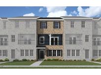 Attractive three-story townhome with brick and siding exterior, front balcony, and green lawn at 217 Broomgrove Way, Wake Forest, NC 27587