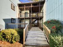 View of the building exterior with stairs, landscaping and walkways at 5038 Flint Ridge Pl, Raleigh, NC 27609