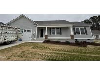 New construction home with gray siding, white trim, and covered front porch at 193 Magnolia Run Way, Benson, NC 27504