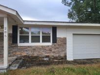 Front exterior of a one-story home with stone accents and attached garage at 206 West Rd, Angier, NC 27501