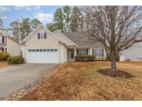 Charming two-story home with a two-car garage, paved driveway, and landscaping at 2204 Regent Ct, Creedmoor, NC 27522