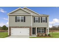 Two-story home with gray siding, stone accents, and a two-car garage at 222 Leven Dr, Gibsonville, NC 27249