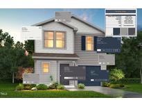 Two-story home with white and navy siding, a covered entryway, and landscaping at 228 Maggie Ln, Roxboro, NC 27573