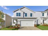 Charming two-story home with a two-car garage and a covered front porch at 14 Tributary Way, Fuquay Varina, NC 27526