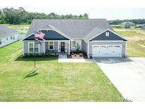 Charming two-story home with a two-car garage and landscaped front yard at 596 Ravensworth Dr, Garner, NC 27529