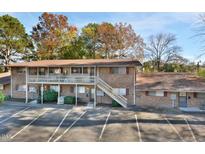 Brick building exterior with parking and a stairway at 130 S Estes Dr # G5, Chapel Hill, NC 27514