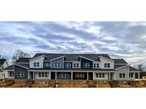 New townhome development showcasing multiple units with modern design and attractive curb appeal at 3919 Willow Gate Way, Raleigh, NC 27604