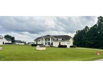 House exterior showcasing a large, ranch style home with a spacious lawn at 6101 Valentine St, Zebulon, NC 27597