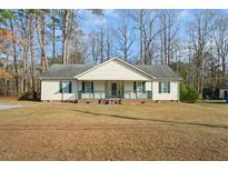 House exterior featuring a front porch and well-maintained lawn at 204 Barbour Rd, Smithfield, NC 27577