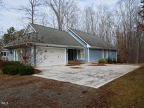 Ranch style home with attached garage and large driveway at 513 Port Dr, Henderson, NC 27537