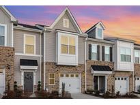 Brick townhome with 2-car garage and charming front porch at 236 George Pine Way, Knightdale, NC 27545