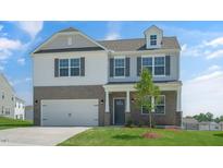 Two-story brick home with gray accents and a large front yard at 28 Tributary Way, Fuquay Varina, NC 27526