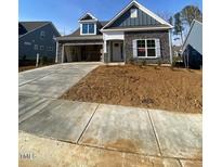 Newly built home with gray siding, stone accents and a two-car garage at 70 Sawtooth Oak Ln, Youngsville, NC 27596