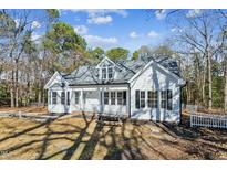 White house with gray roof, front porch, and picnic table in the yard at 309 Monterey Ct, Benson, NC 27504