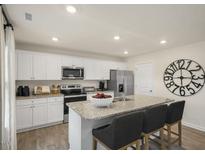 Modern kitchen with stainless steel appliances and granite countertops at 103 Reagan Crest Dr, Clayton, NC 27520