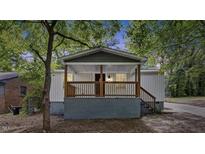 Newly renovated house featuring a charming front porch and gray siding at 1545 Tadlock Ave Ave, Rocky Mount, NC 27801