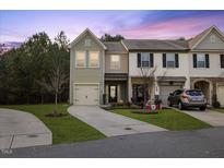 Two-story townhome with attached garage and landscaped front yard at 3735 Landshire View Ln, Raleigh, NC 27616