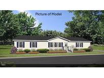 Single-story home with a neutral color palette and landscaping at 6016 Charlies Deadend Rd, Efland, NC 27243