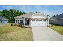 Two-story home with stone accents and a two-car garage at 152 Northwood Dr, Fuquay Varina, NC 27526