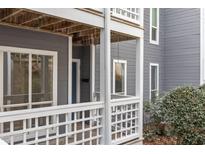 Gray condo building with white trim, balconies, and surrounding trees at 4651 Timbermill Ct # 103, Raleigh, NC 27612