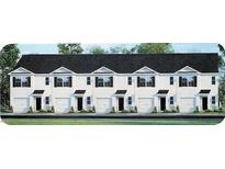 Front view of a townhome community showcasing multiple units with attached garages at 511 Fife Ct., Gibsonville, NC 27249