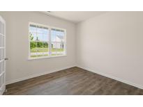 Bright home office features wood-look floors and a large window at 1129 Middlecrest Dr, Rocky Mount, NC 27804